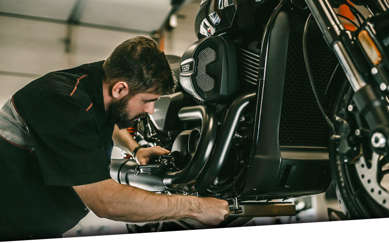 Harley service guy working on a bike 